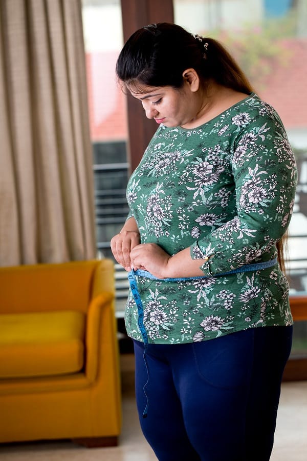 Obese woman measuring her belly Obesity Treatments 2 Sai Ayush Ayurveda Hyderabad