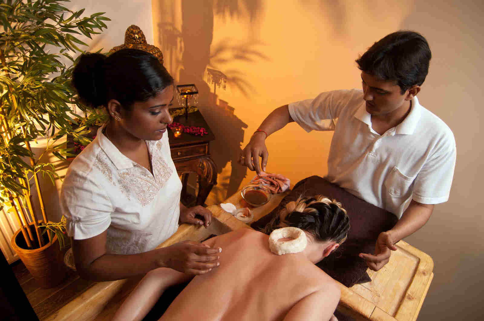 Ayurvedic treatment session at Sai Ayush Ayurveda in KPHB, Hyderabad. Two practitioners attending to a patient lying on a massage table, offering therapies in a serene setting.