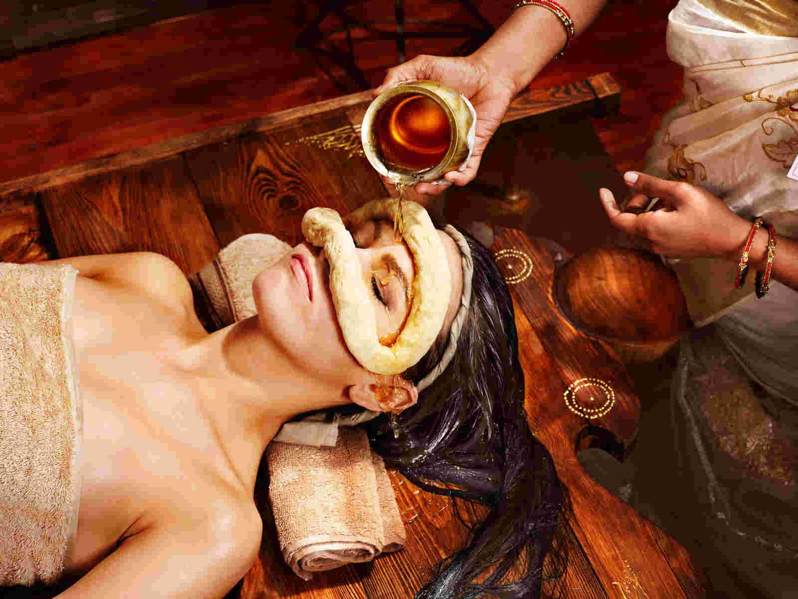 A person receiving Shirodhara treatment at Sai Ayush Ayurveda, an Ayurvedic therapy involving the pouring of warm oil over the forehead, in KPHB, Hyderabad.